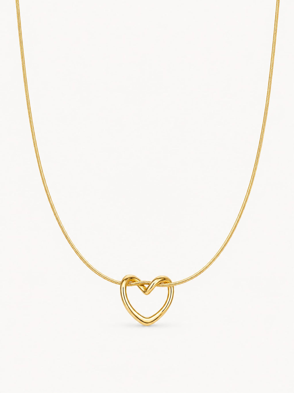 A delicate gold chain necklace featuring a small, open heart-shaped pendant with a polished finish, shown against a plain off-white background.