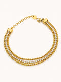 Celeste Triple Strand Bracelet in 18K gold plated stainless steel featuring dual polished bead chains and a sparkling white CZ tennis strand.