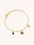 Celestial Evil Eye Charm Bracelet in 18K gold plated stainless steel featuring a sparkling evil eye charm, blue teardrop crystal, and sun charm with CZ accents.
