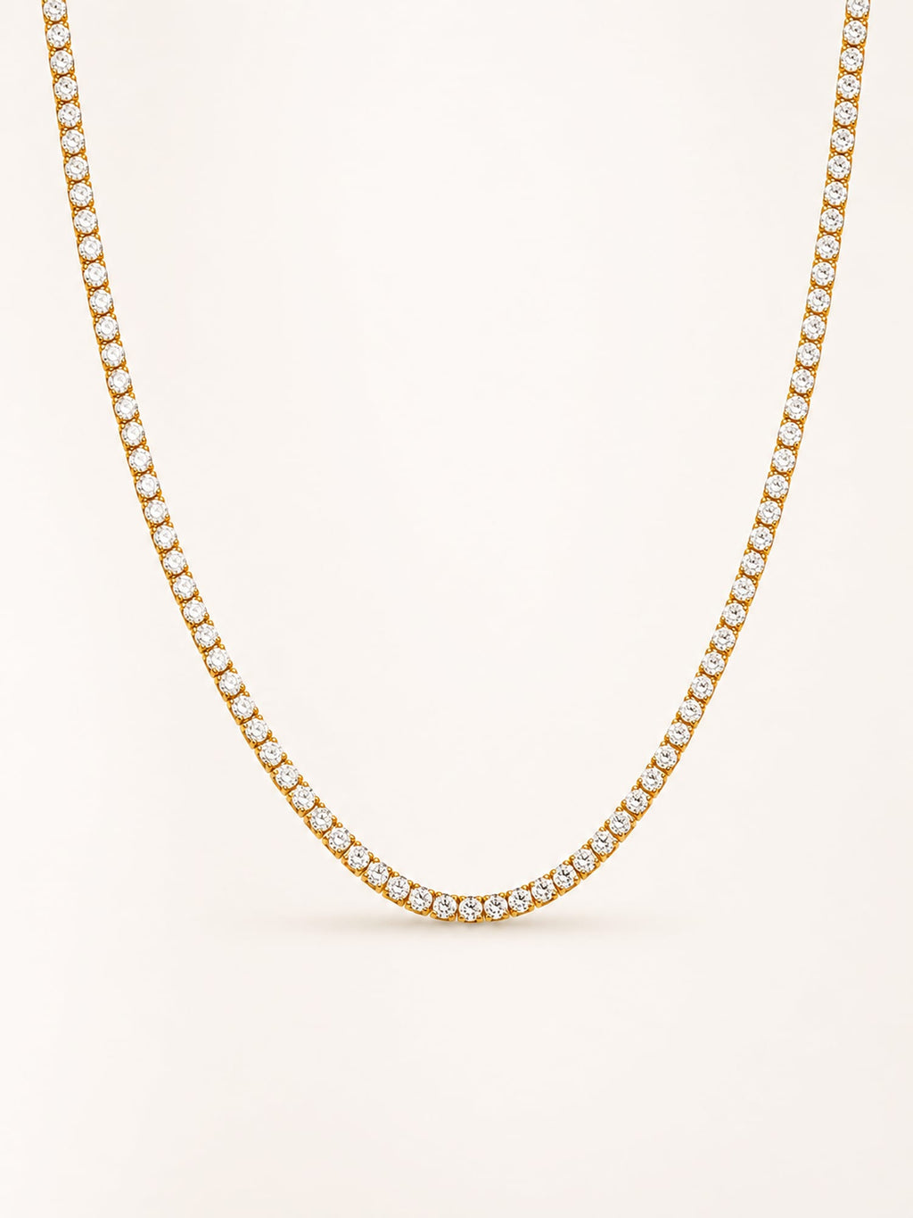 Classic white CZ tennis necklace in 18K gold plated stainless steel with a continuous row of brilliant round stones.