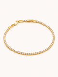 Classic Tennis Bracelet in 18K gold plated stainless steel featuring a continuous row of brilliant round white CZ stones with a secure box clasp.