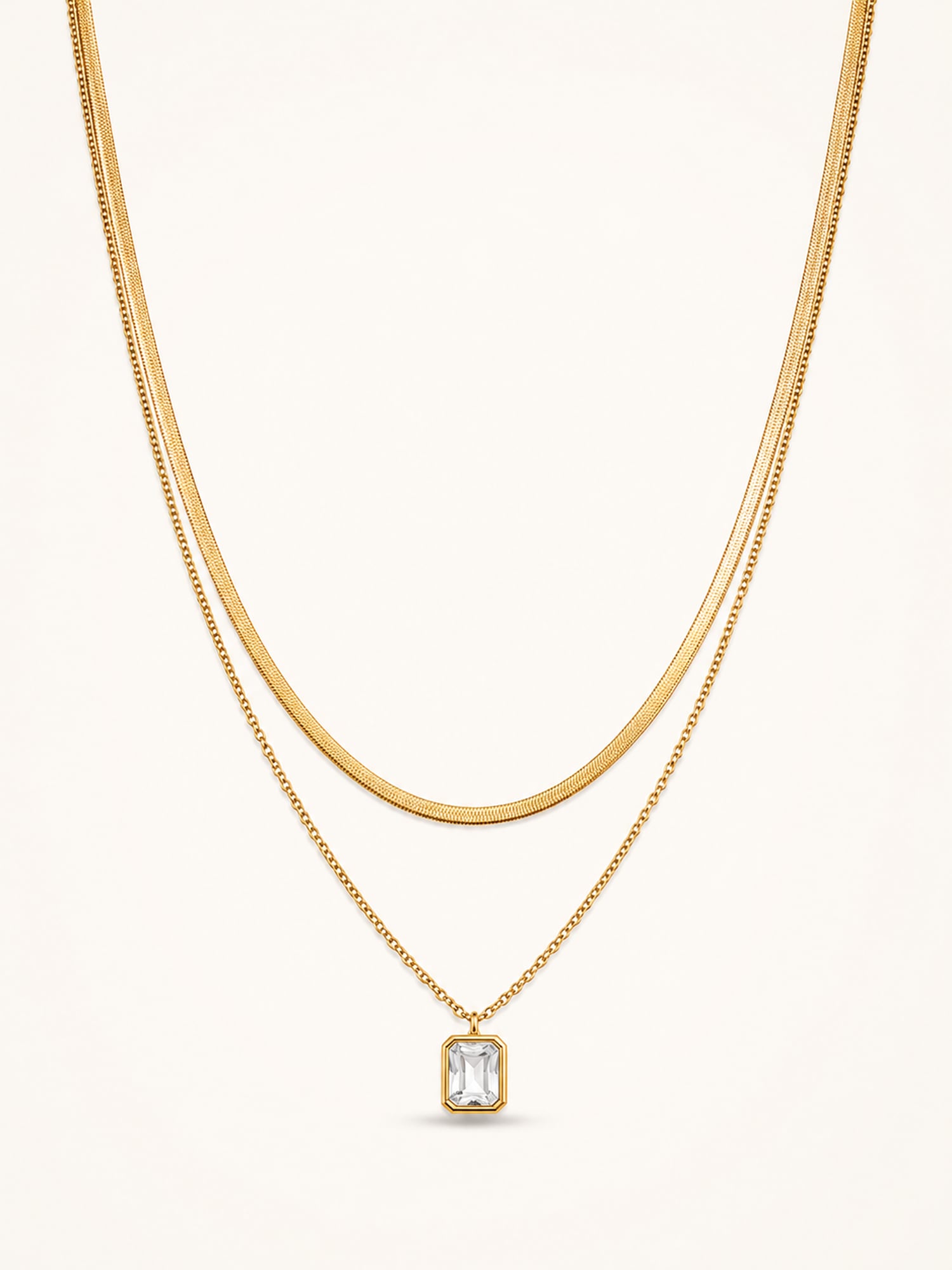 18K gold plated layered necklace with emerald cut cubic zirconia pendant on white background