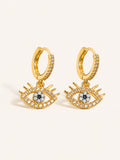 Gold evil eye drop huggie earrings featuring clear, black and white cubic zirconia accents.