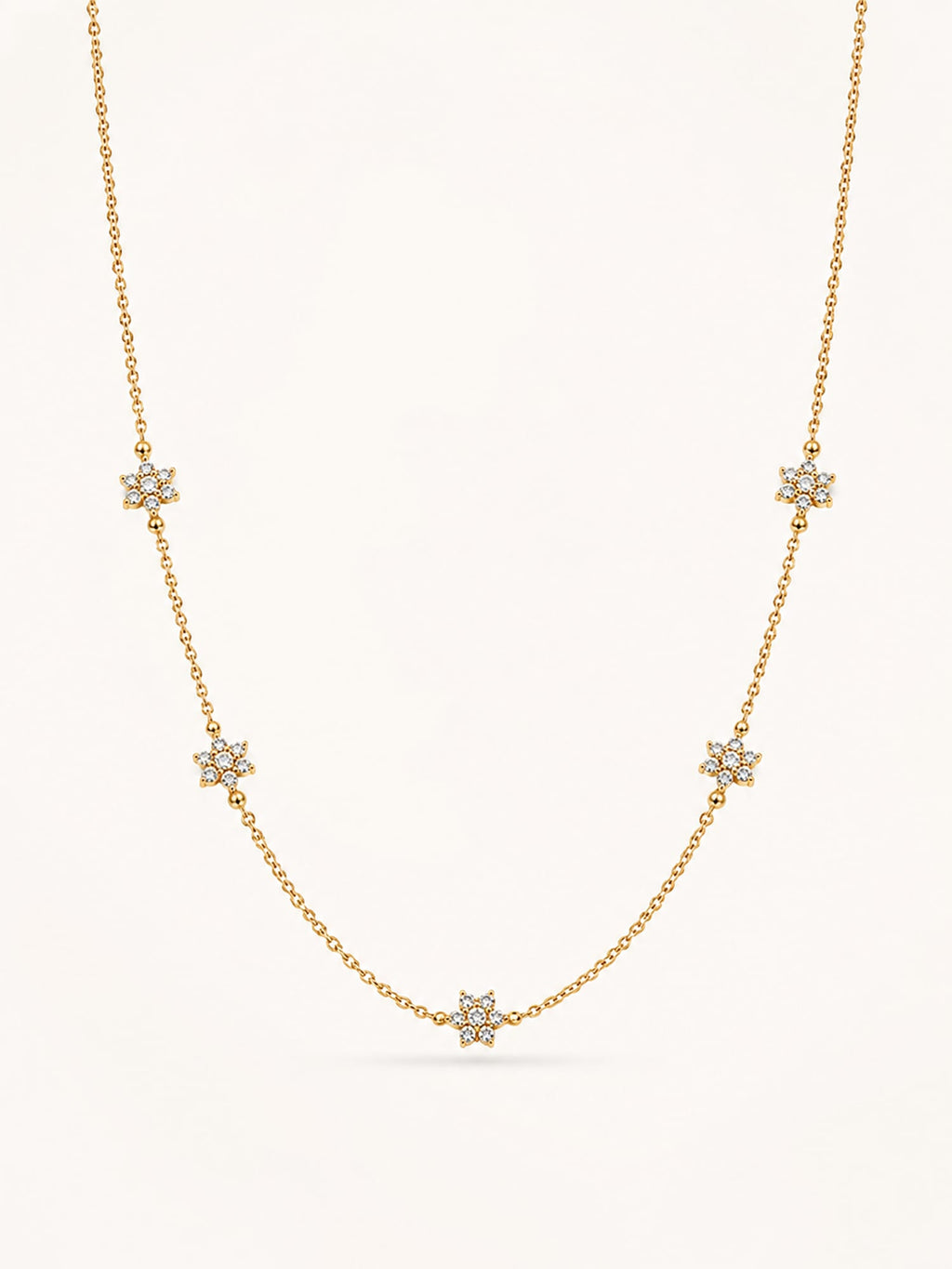 Floral CZ station necklace in 18K gold plated stainless steel featuring five sparkling flower motifs on a delicate chain.