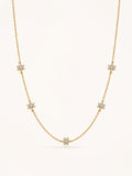 Floral CZ station necklace in 18K gold plated stainless steel featuring five sparkling flower motifs on a delicate chain.