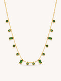 Green CZ station necklace featuring alternating round and baguette-cut stones in an 18K gold plated stainless steel chain.