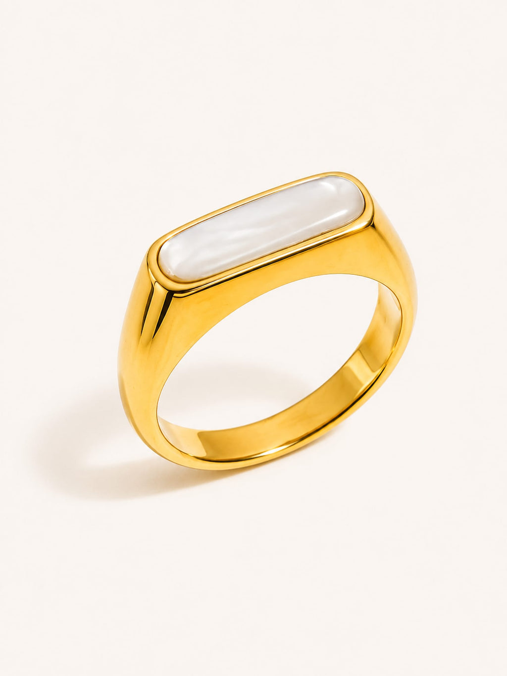 Mother of pearl signet ring with a polished gold finish and minimalist rectangular design.