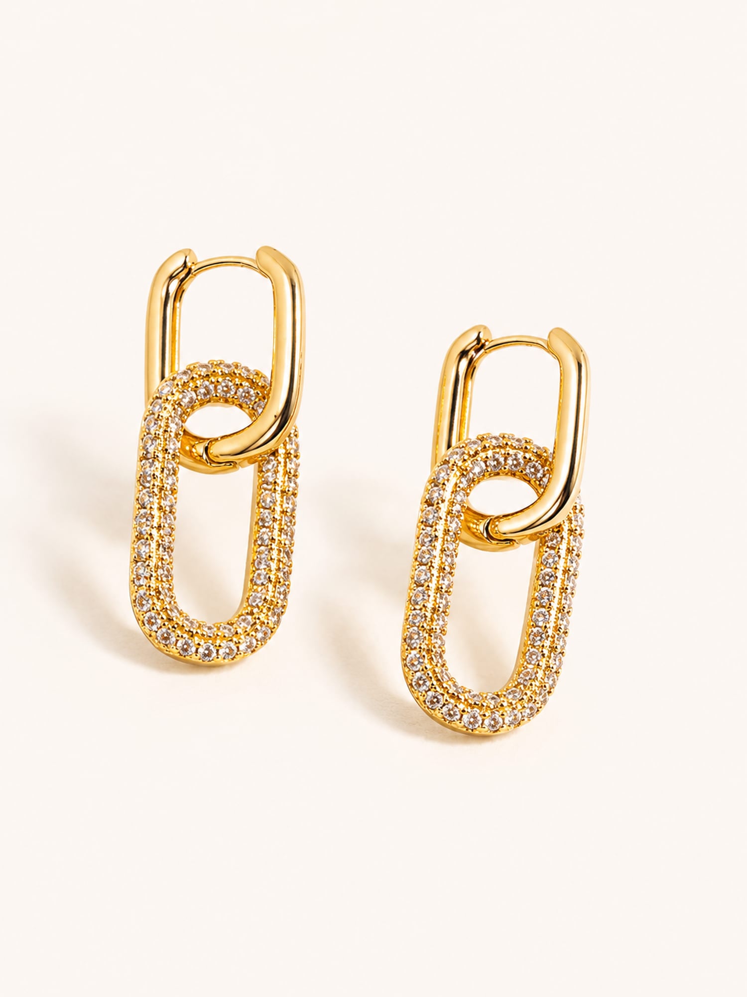 Gold pavé link drop earrings featuring clear cubic zirconia in a modern interlocking chain design.