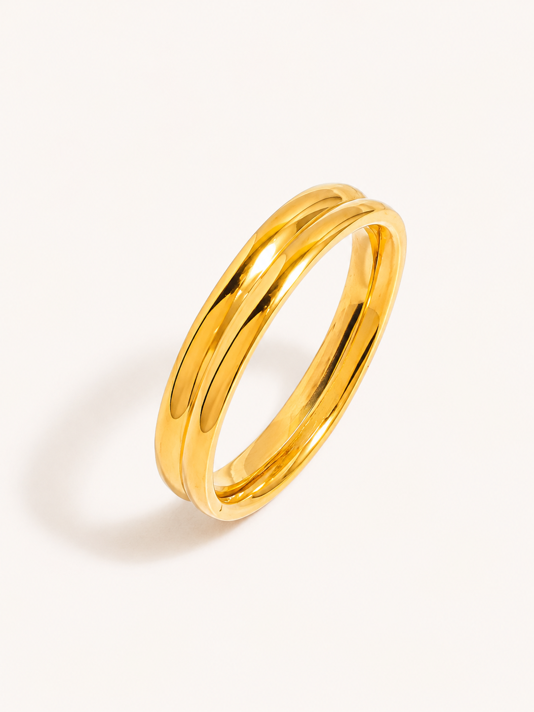 Rounded band ring in polished gold finish with a sleek minimalist design.