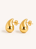 Polished gold teardrop stud earrings in stainless steel with a sculptural minimalist design.